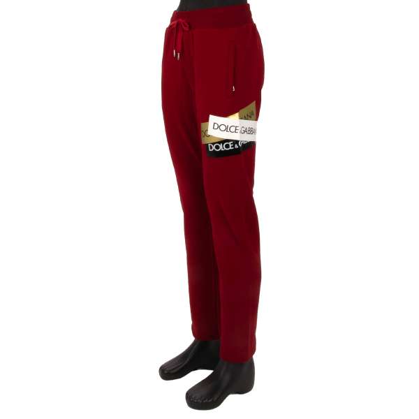 Cotton Track Pants / Joggings with DG Logo patches, elastic waist and zipped pockets in red by DOLCE & GABBANA